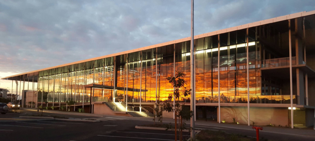 KDV Golf and Tennis Academy, earlier image of front elevation looking slightly east at sunrise, taken on a builder's phone camera.